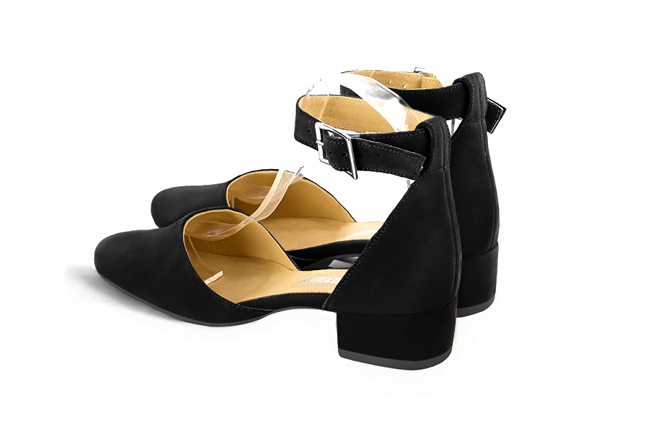 Women's matt black open side dress shoes, with a strap around the ankle. Round toe. Low block heels - Rear view
